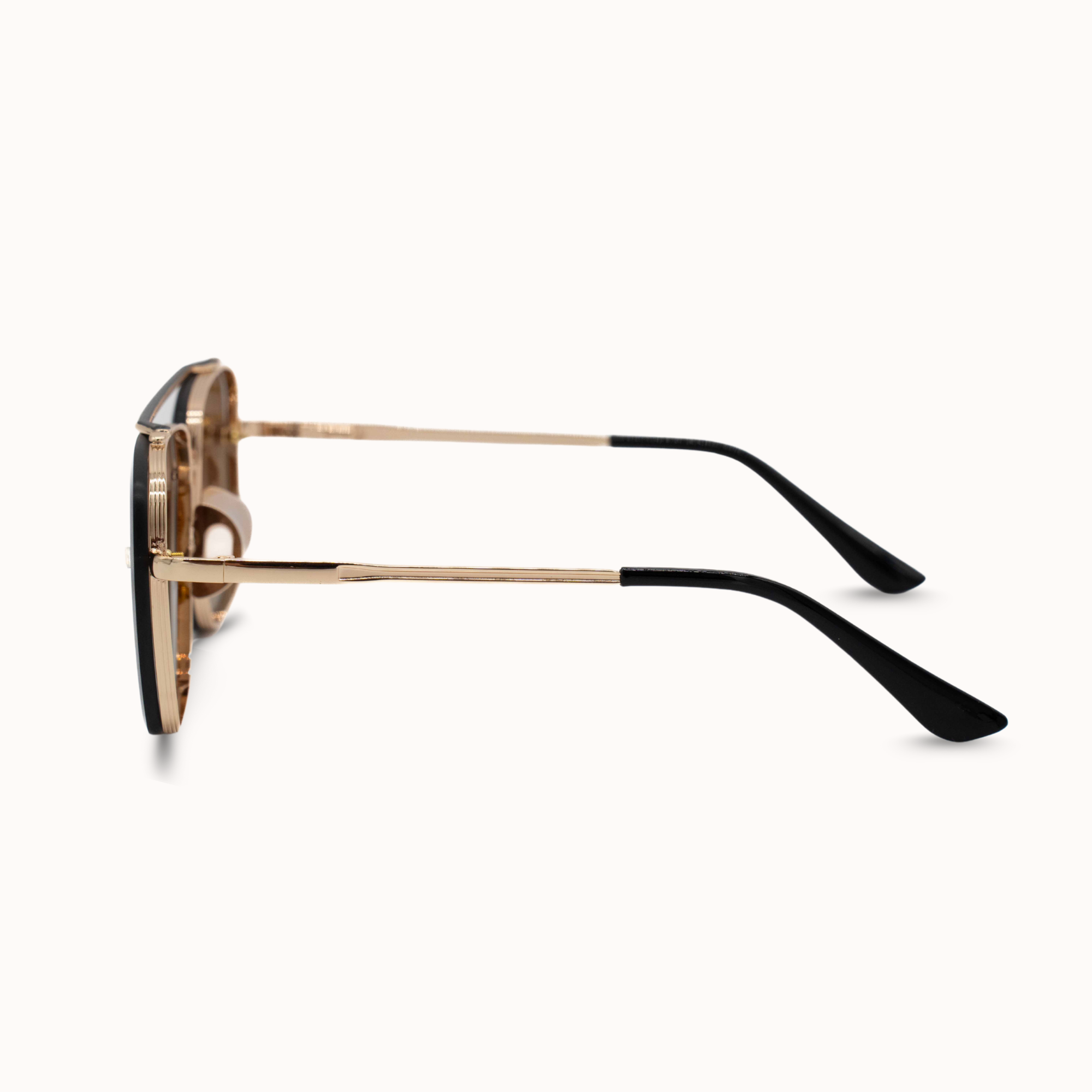 Sunglasses with gold frame and black arms on a white background