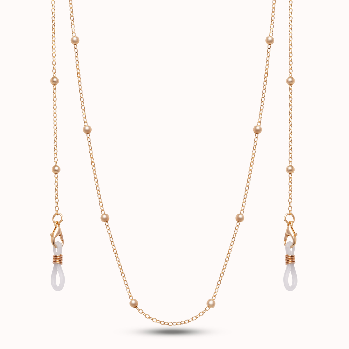 A delicate gold double-strand necklace featuring small bead accents and two drop pendants with white teardrop-shaped beads wrapped in rose gold wire, displayed against a clean white background.