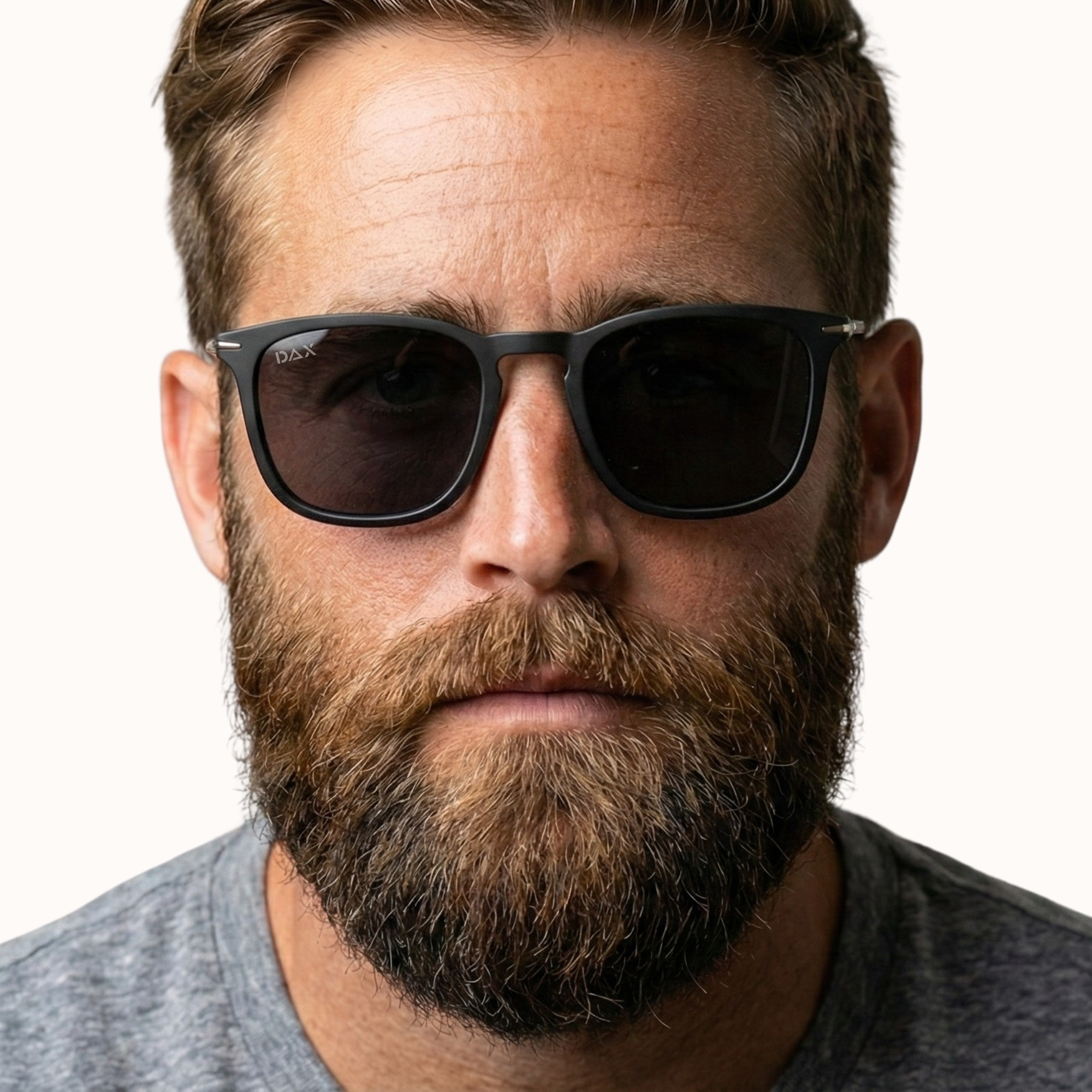 Man wearing dark sunglasses with a neutral background
