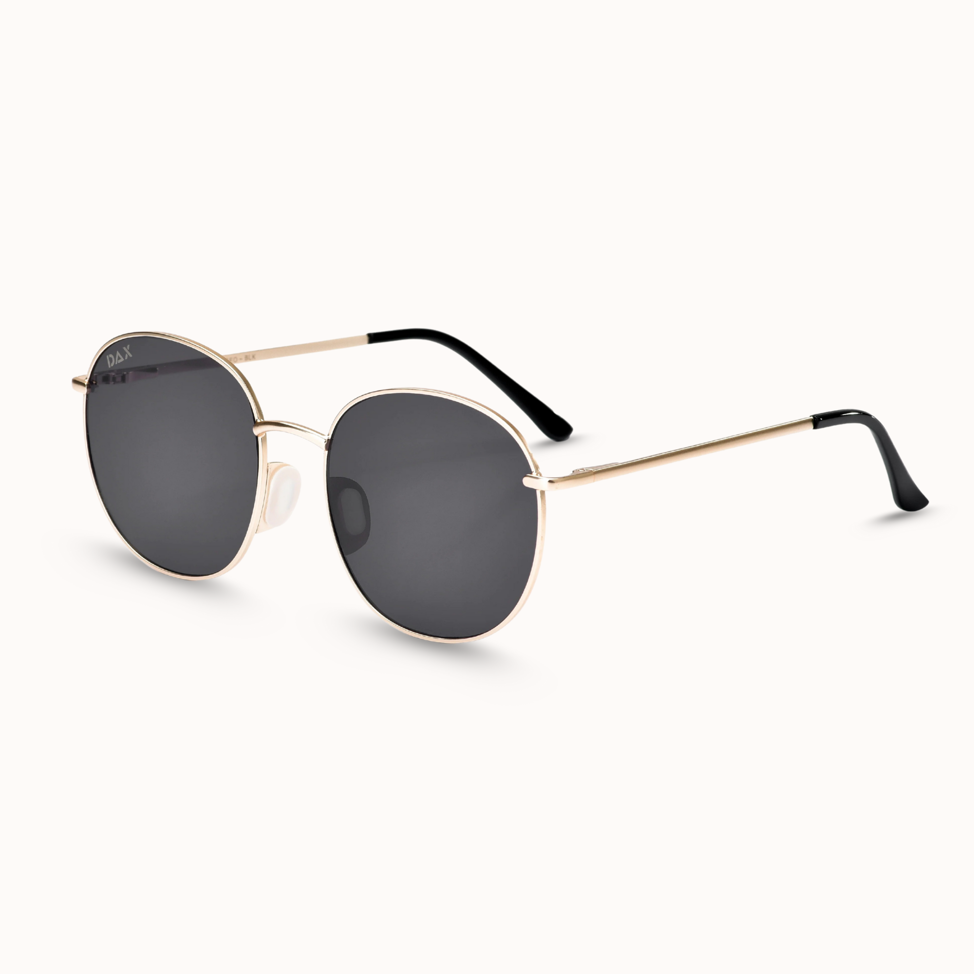 Gold-framed sunglasses with dark lenses on a white background