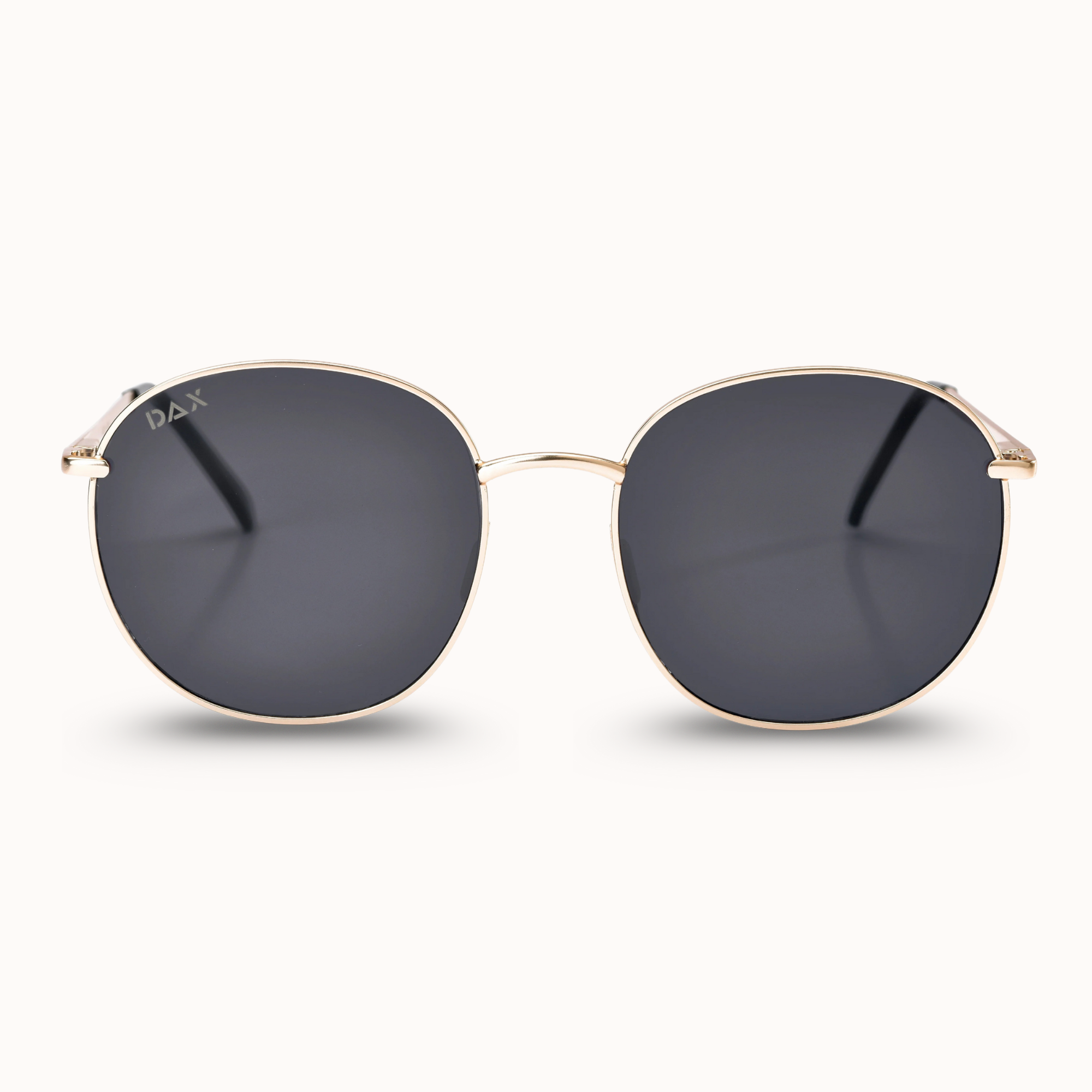 Gold-framed sunglasses with dark lenses on a white background