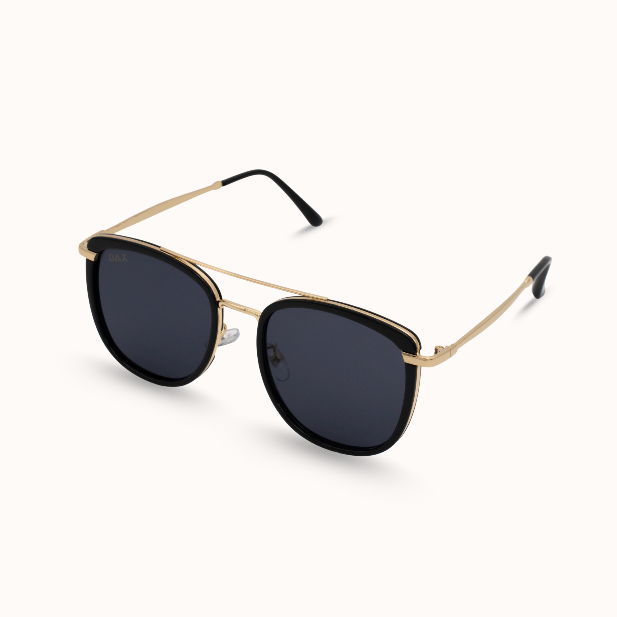 Sunglasses with gold frame and black lenses on a white background