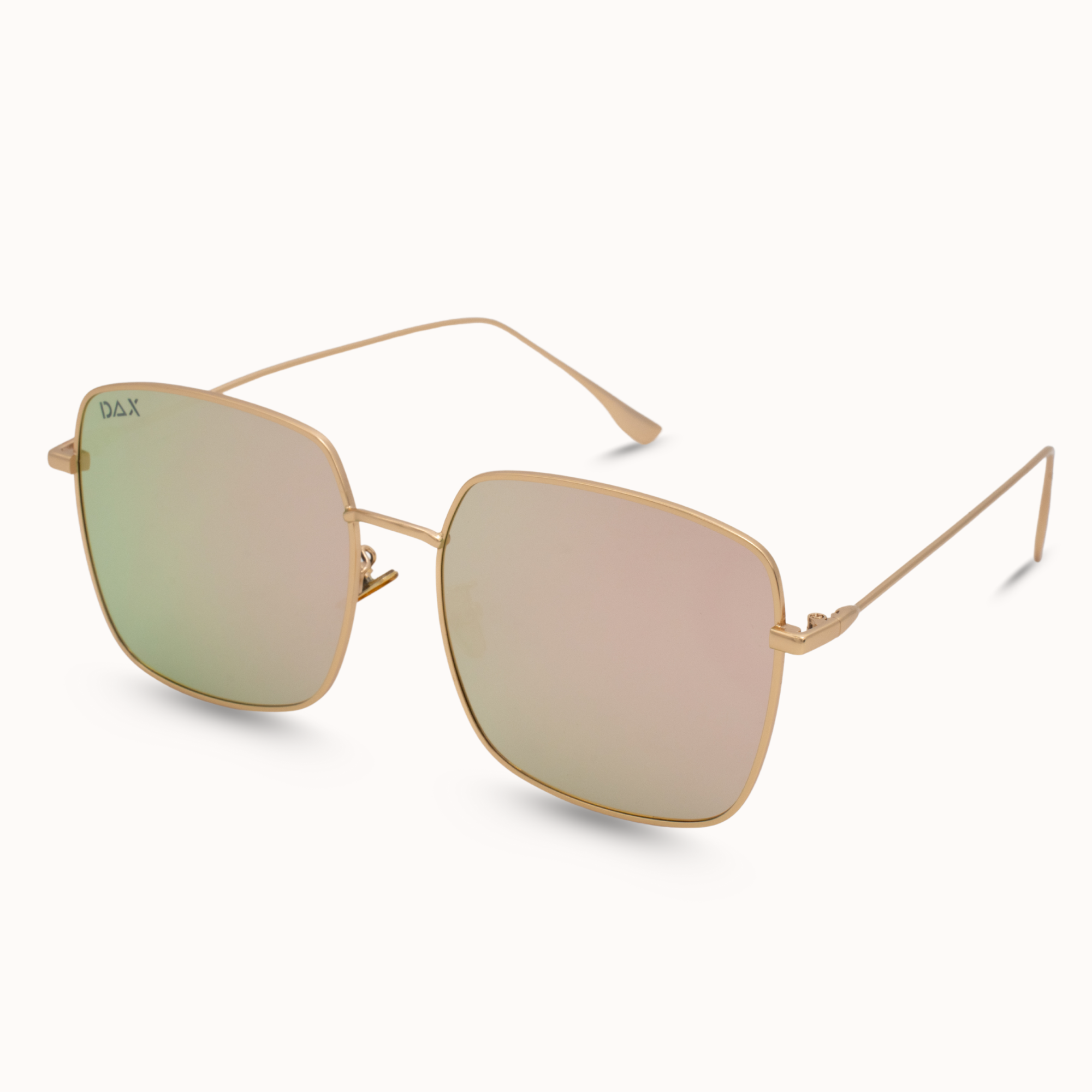 Gold-framed sunglasses with pink-tinted lenses on a white background