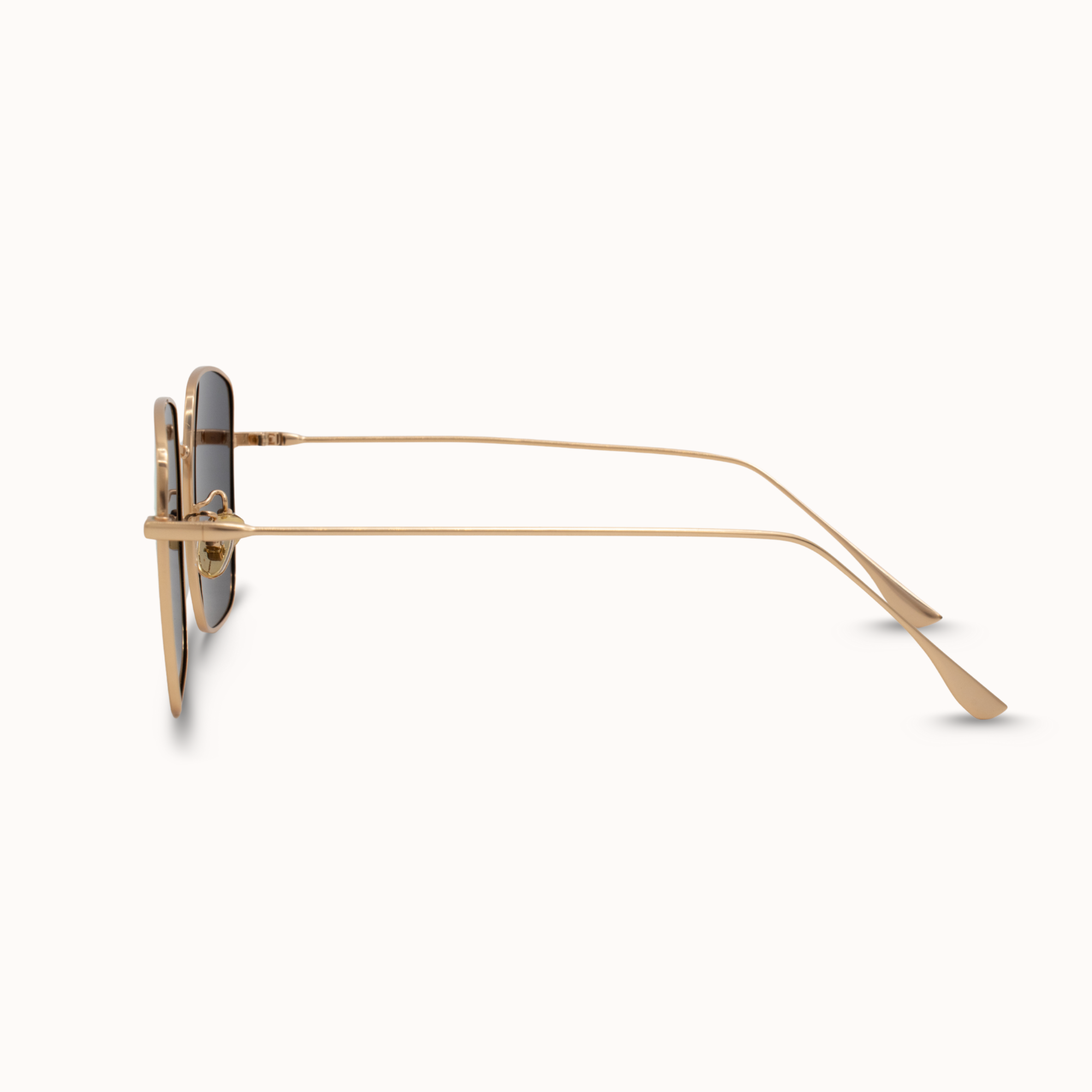 Gold sunglasses with a white background