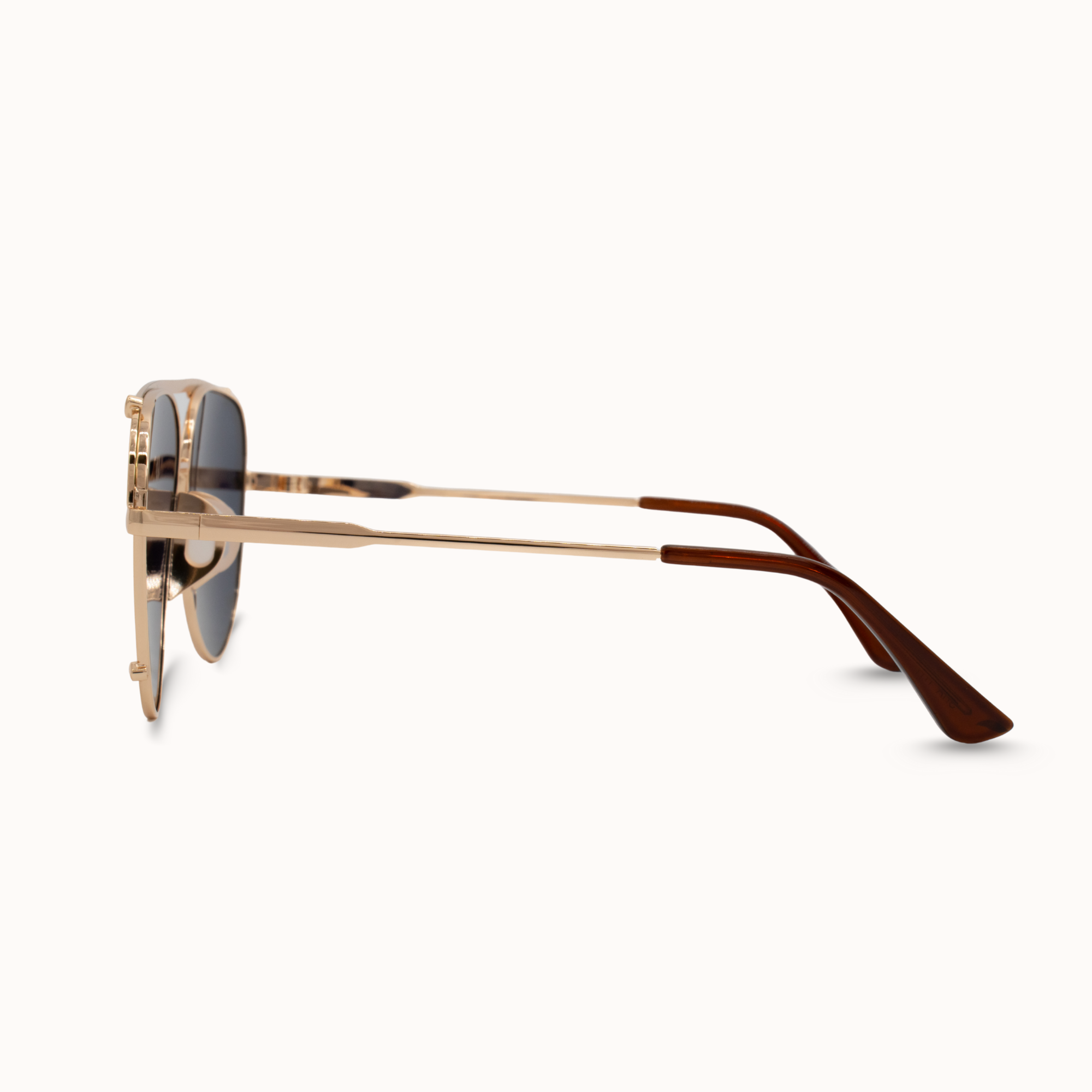 Gold-framed sunglasses on a white background