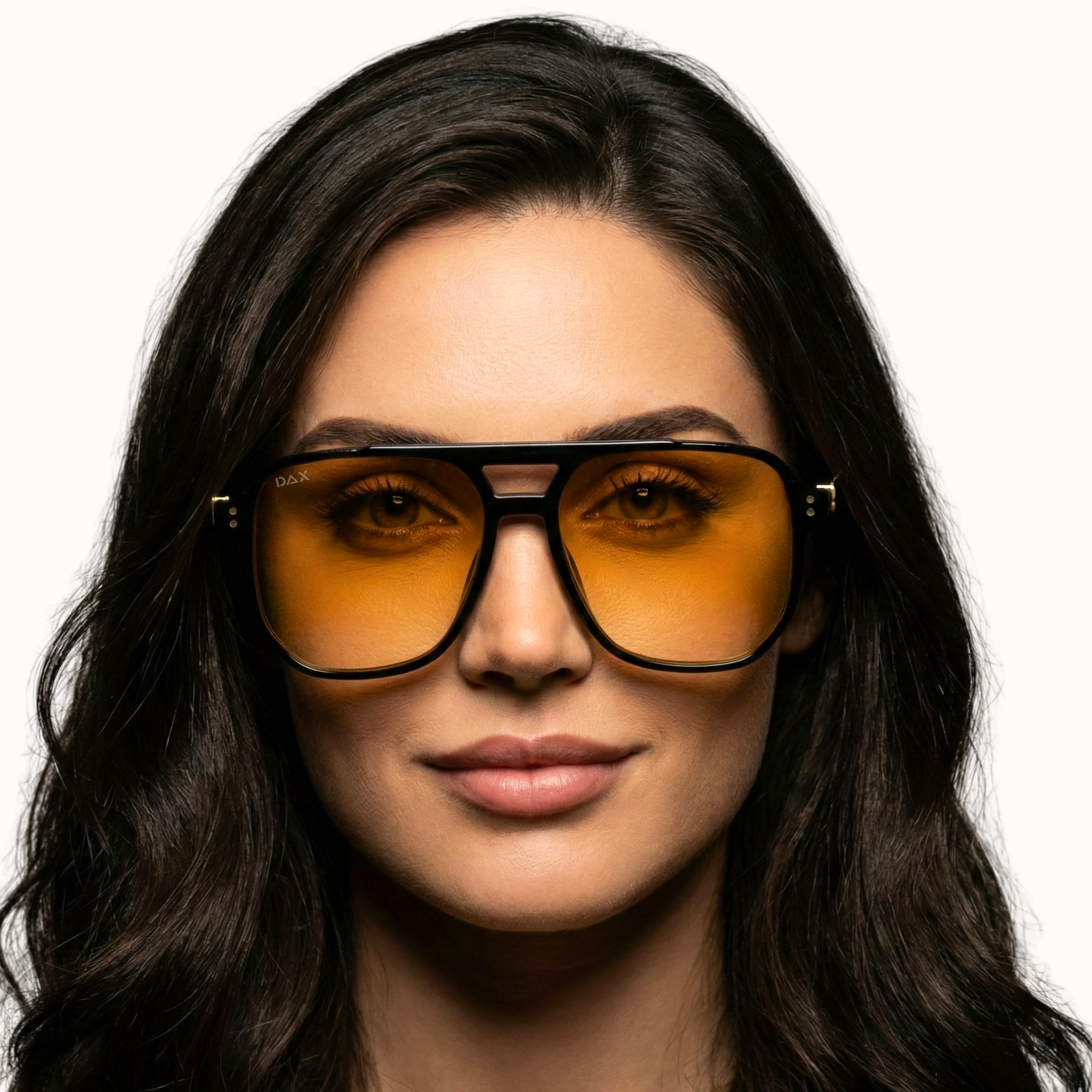 Woman wearing orange-tinted sunglasses with a plain background