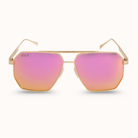 Sunglasses with pink lenses and gold frame on a white background