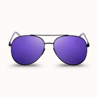 Sunglasses with purple lenses and black frames on a white background