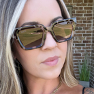 Woman wearing sunglasses with a blurred background