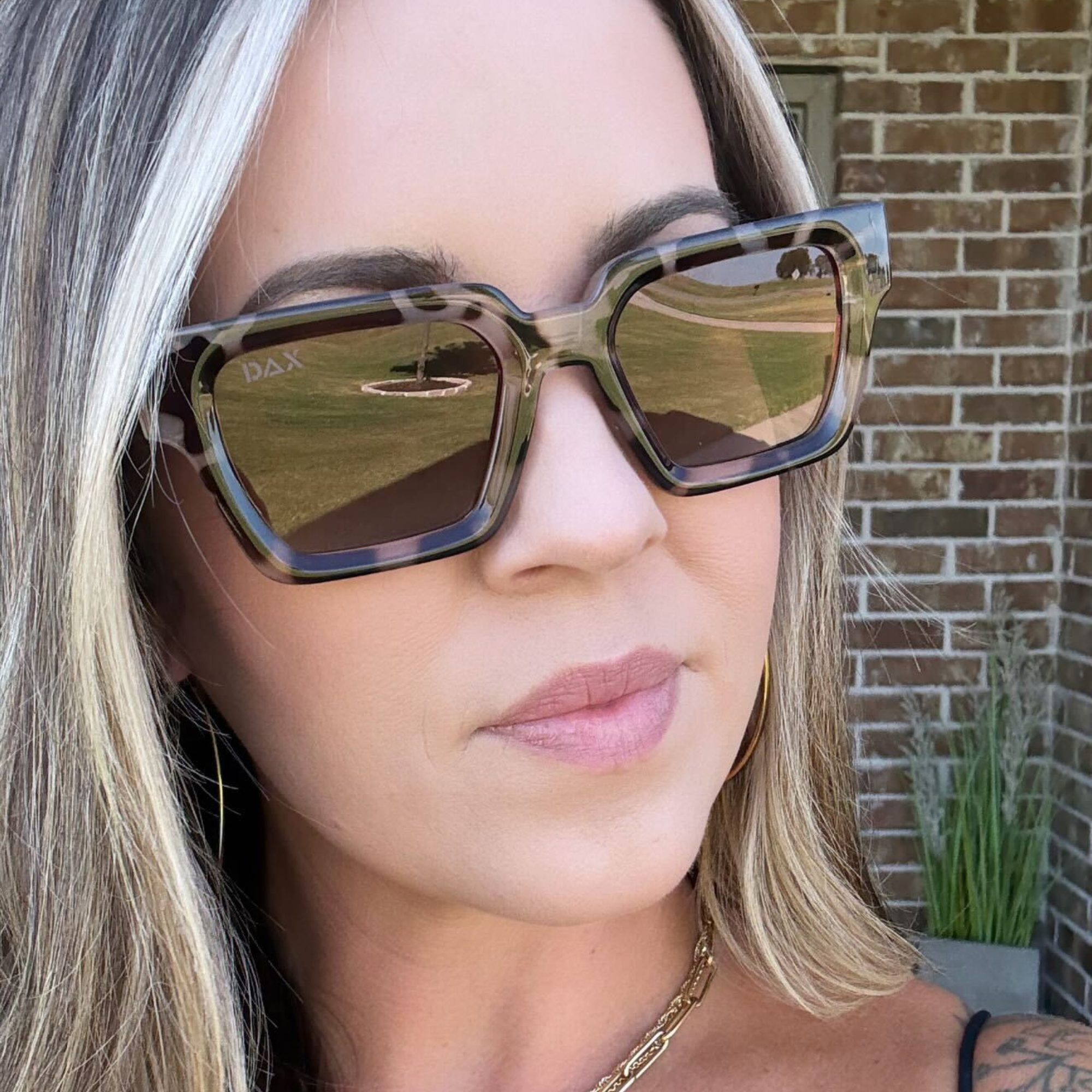 Woman wearing sunglasses with a blurred background