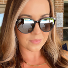 Woman wearing black sunglasses with a blurred background
