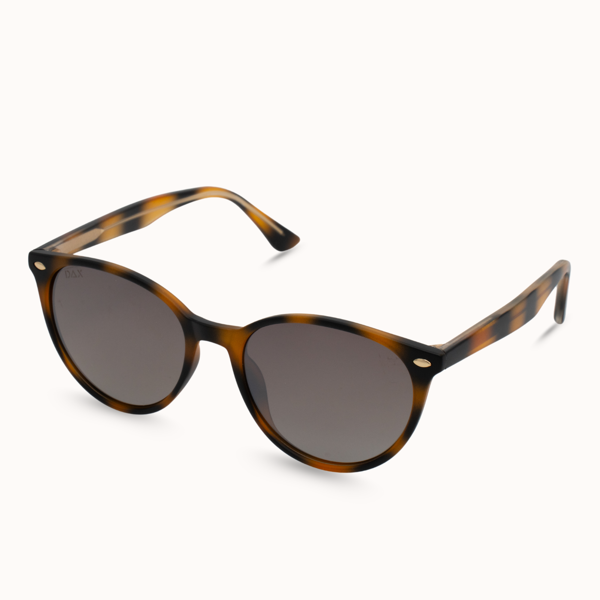 Sunglasses with tortoiseshell frame and dark lenses on a white background