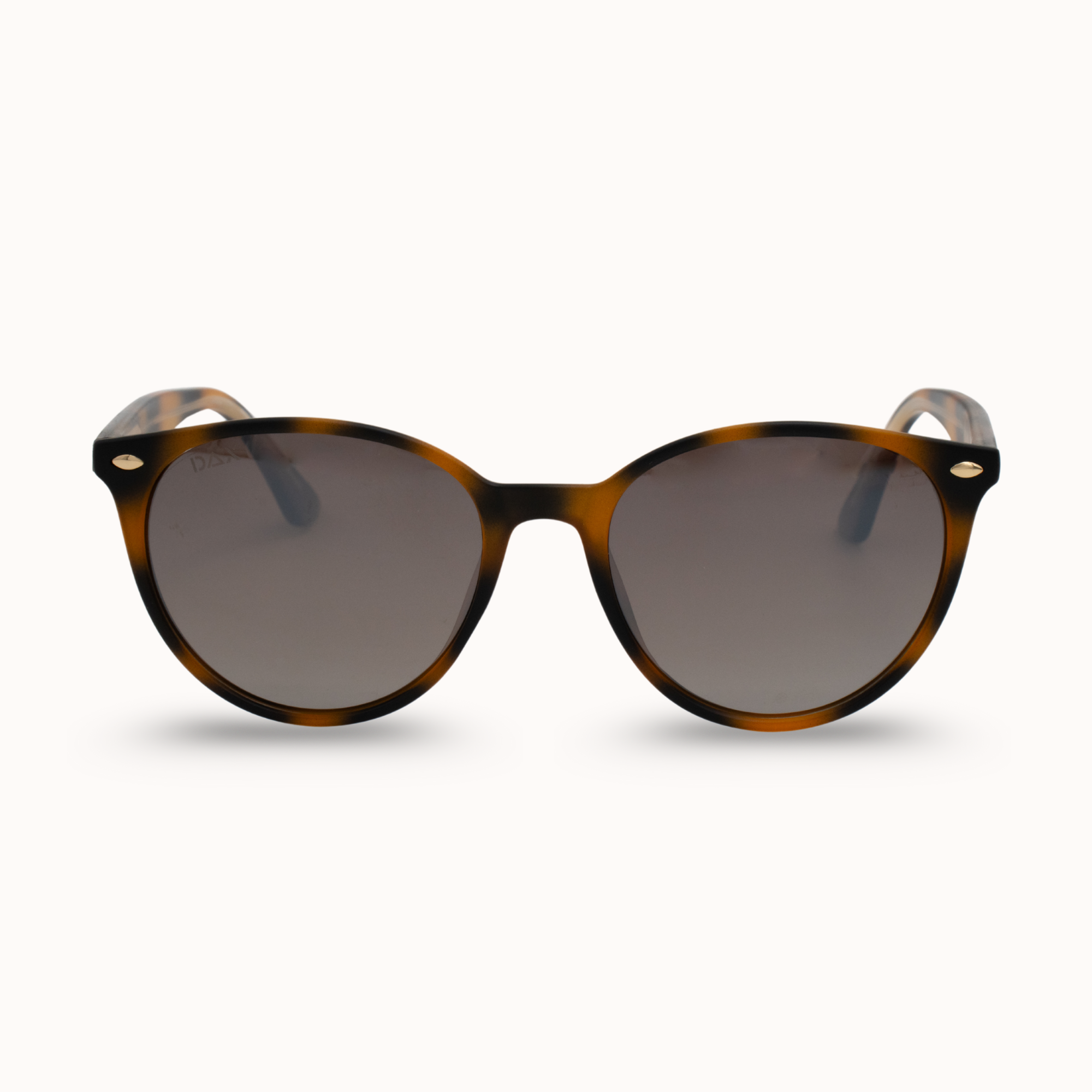 Sunglasses with tortoiseshell frame and dark lenses on a white background