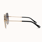 Sunglasses with gold frame and black arms on a white background
