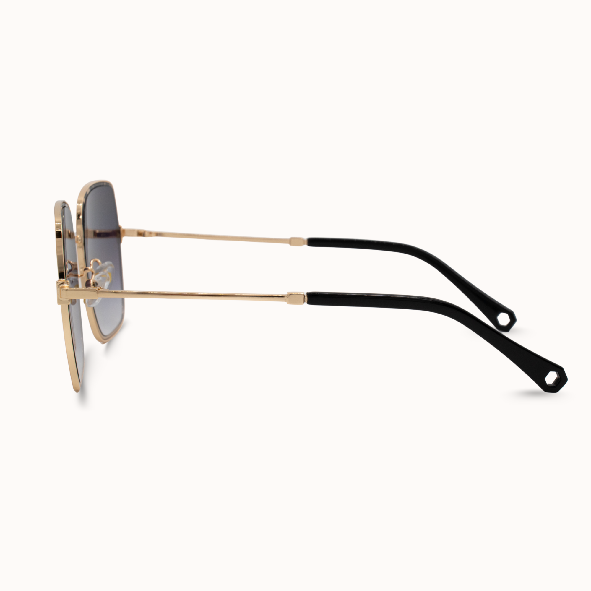 Sunglasses with gold frame and black arms on a white background