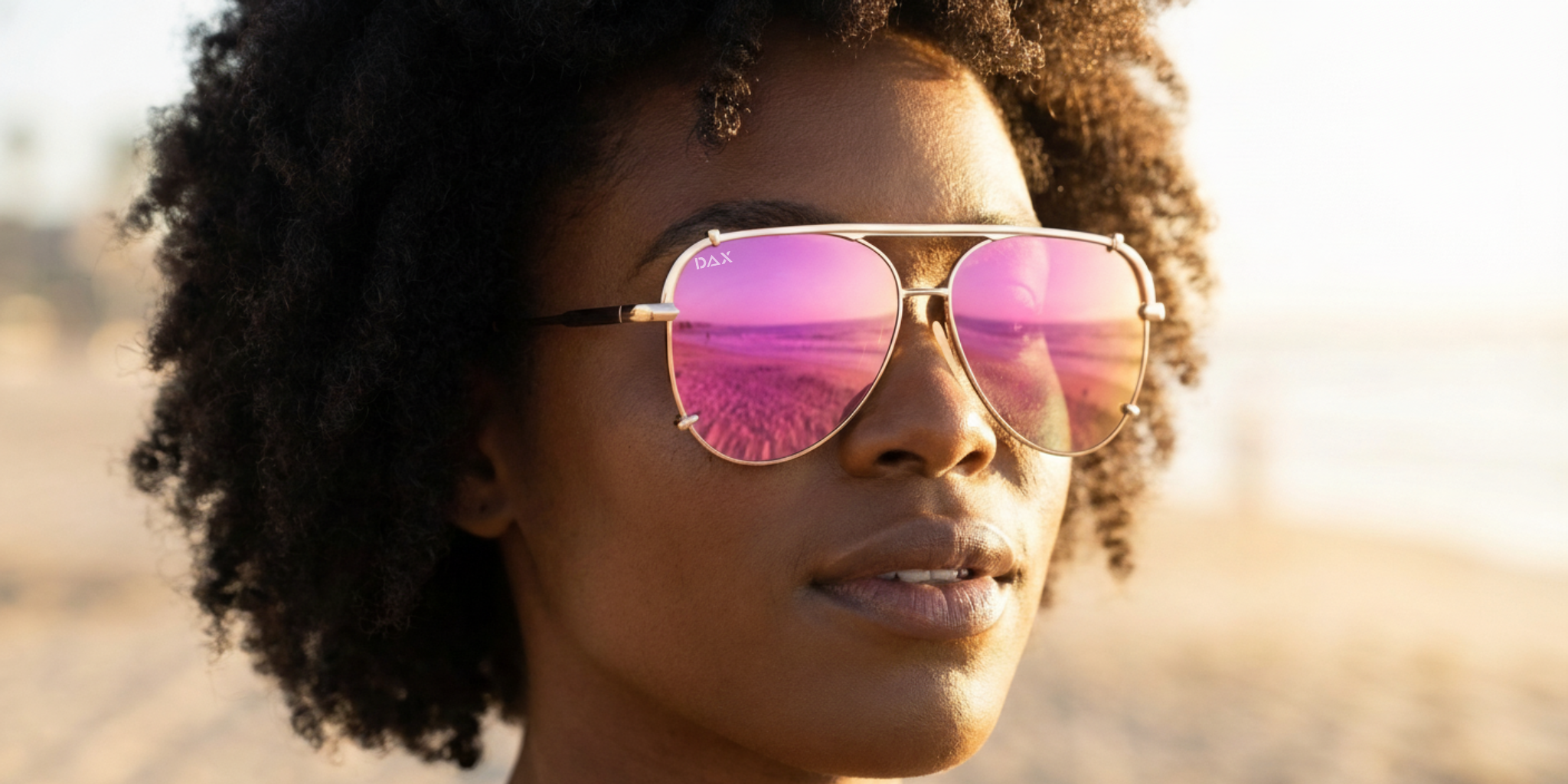 Person wearing pink reflective sunglasses with a blurred natural background