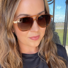 Woman wearing sunglasses with a blurred outdoor background