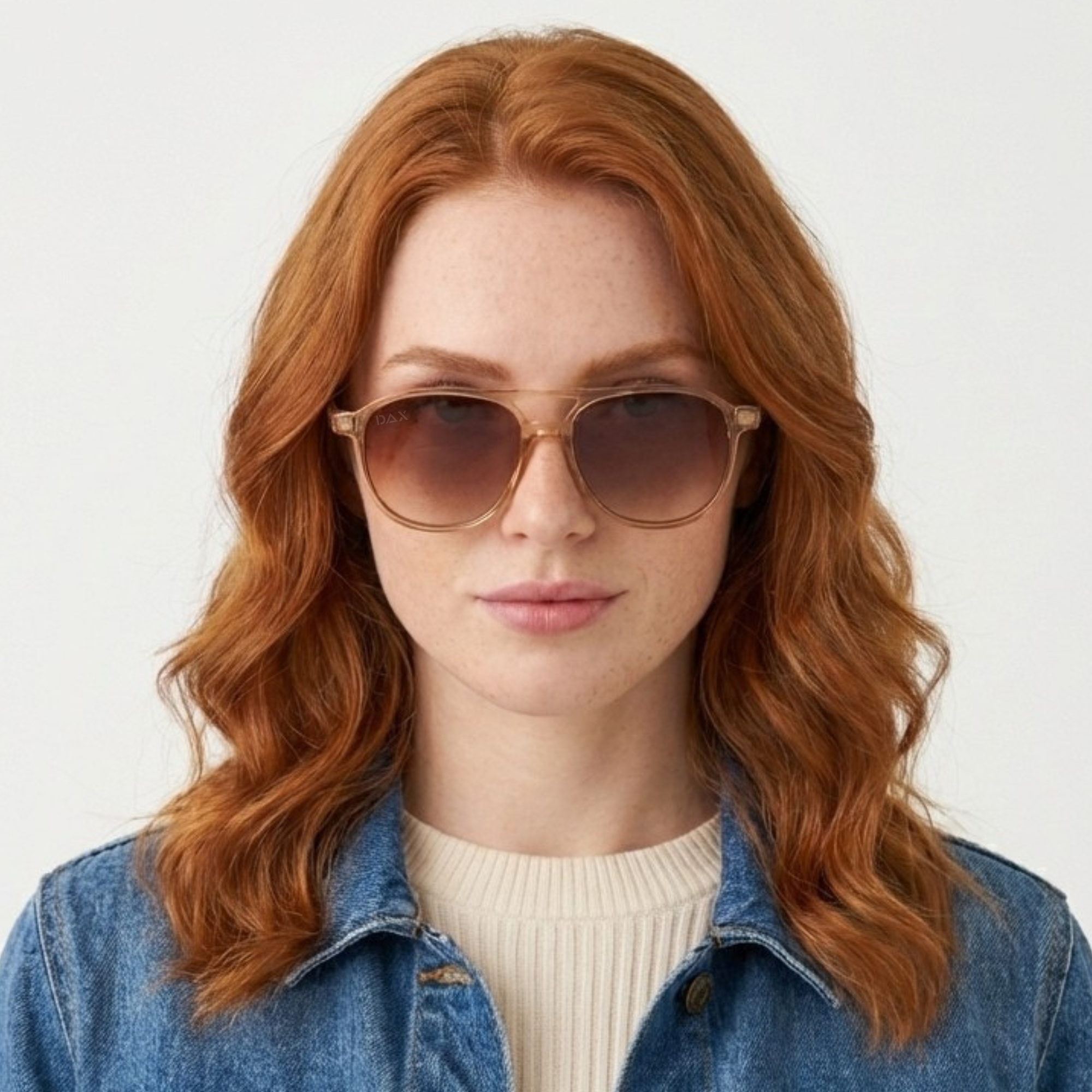 Woman wearing sunglasses and a denim jacket on a white background