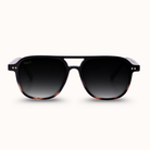 Sunglasses with a black frame and gradient lenses on a white background