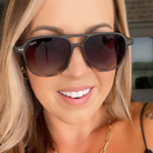 Woman wearing dark sunglasses with a blurred background