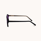Black sunglasses with a purple lens on a white background