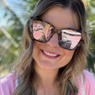Woman wearing sunglasses with a blurred outdoor background