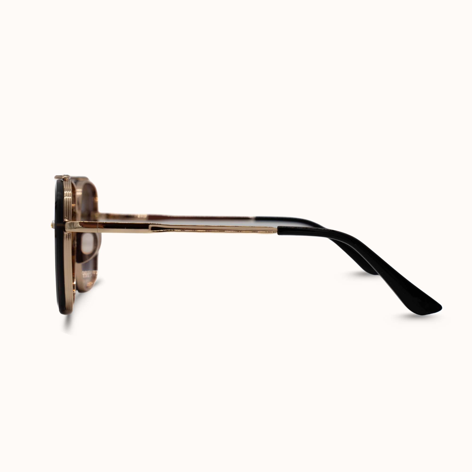 Sunglasses with gold frame and black arms on a white background