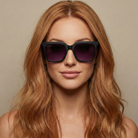 Woman wearing black sunglasses with a neutral background
