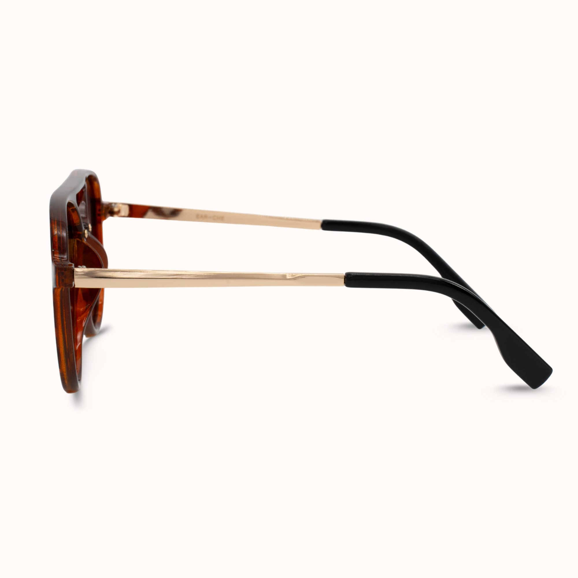 Sunglasses with tortoiseshell frame and black arms on a white background