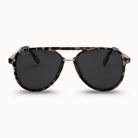 Sunglasses with tortoiseshell frame and dark lenses on a white background