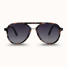 Sunglasses with tortoiseshell frame and dark lenses on a white background