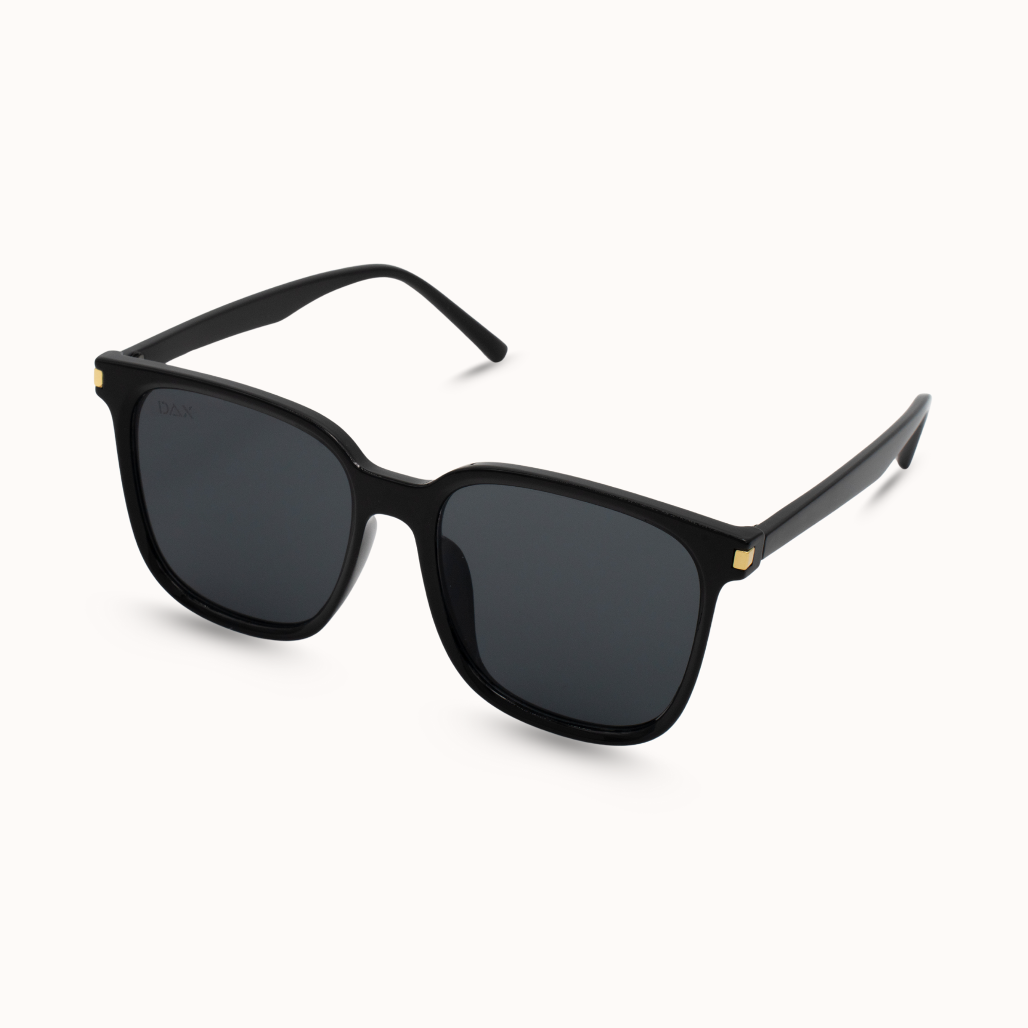 Black sunglasses with gold accents on a white background