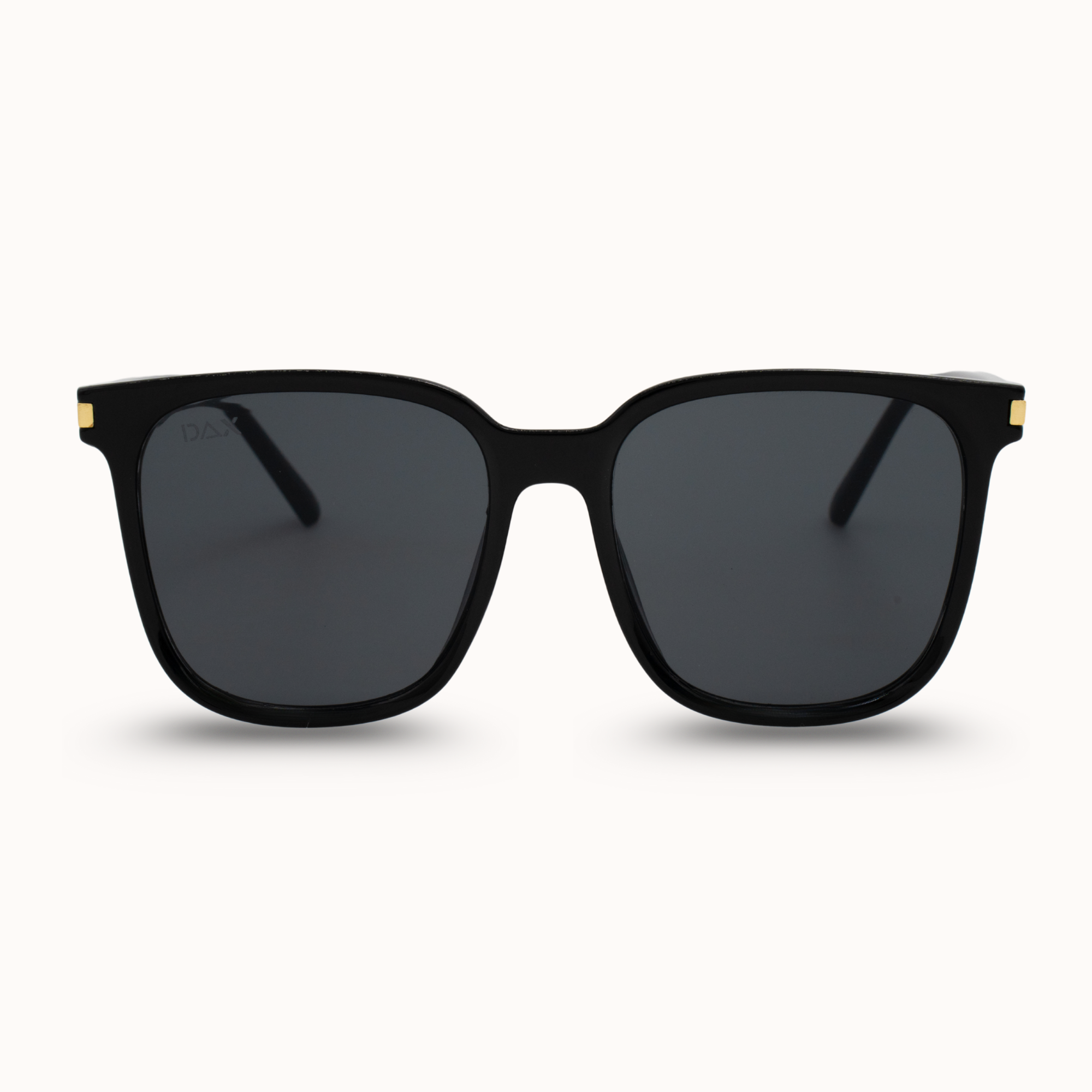 Black sunglasses with gold accents on a white background