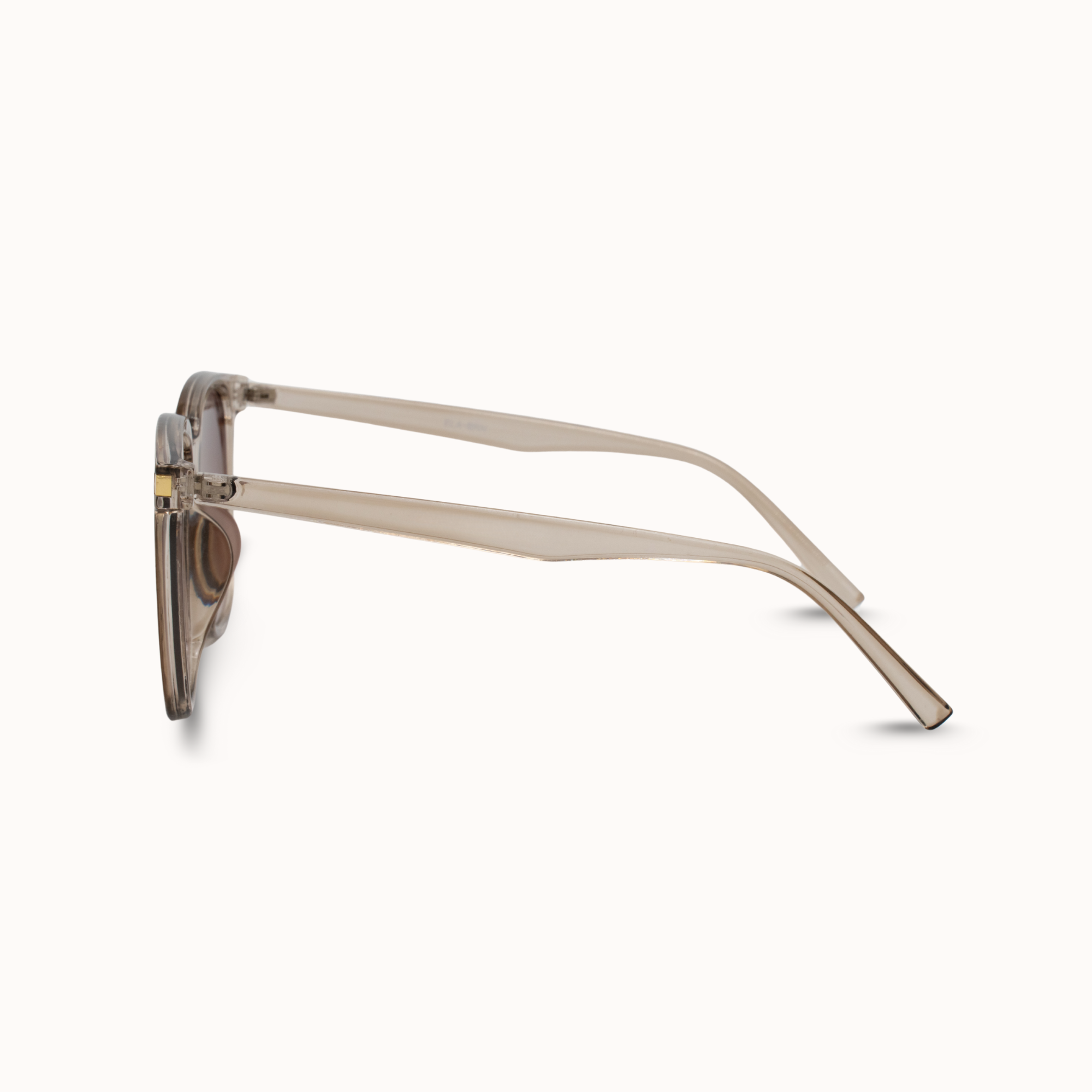 Sunglasses with beige frame and dark lenses on a white background