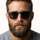 Man wearing dark sunglasses with a neutral background