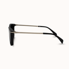 Sunglasses with black lenses and black and gold frame on a white background