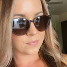 Close-up of a person wearing sunglasses with a neutral background