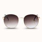 Sunglasses with gold frame and gradient lenses on a white background