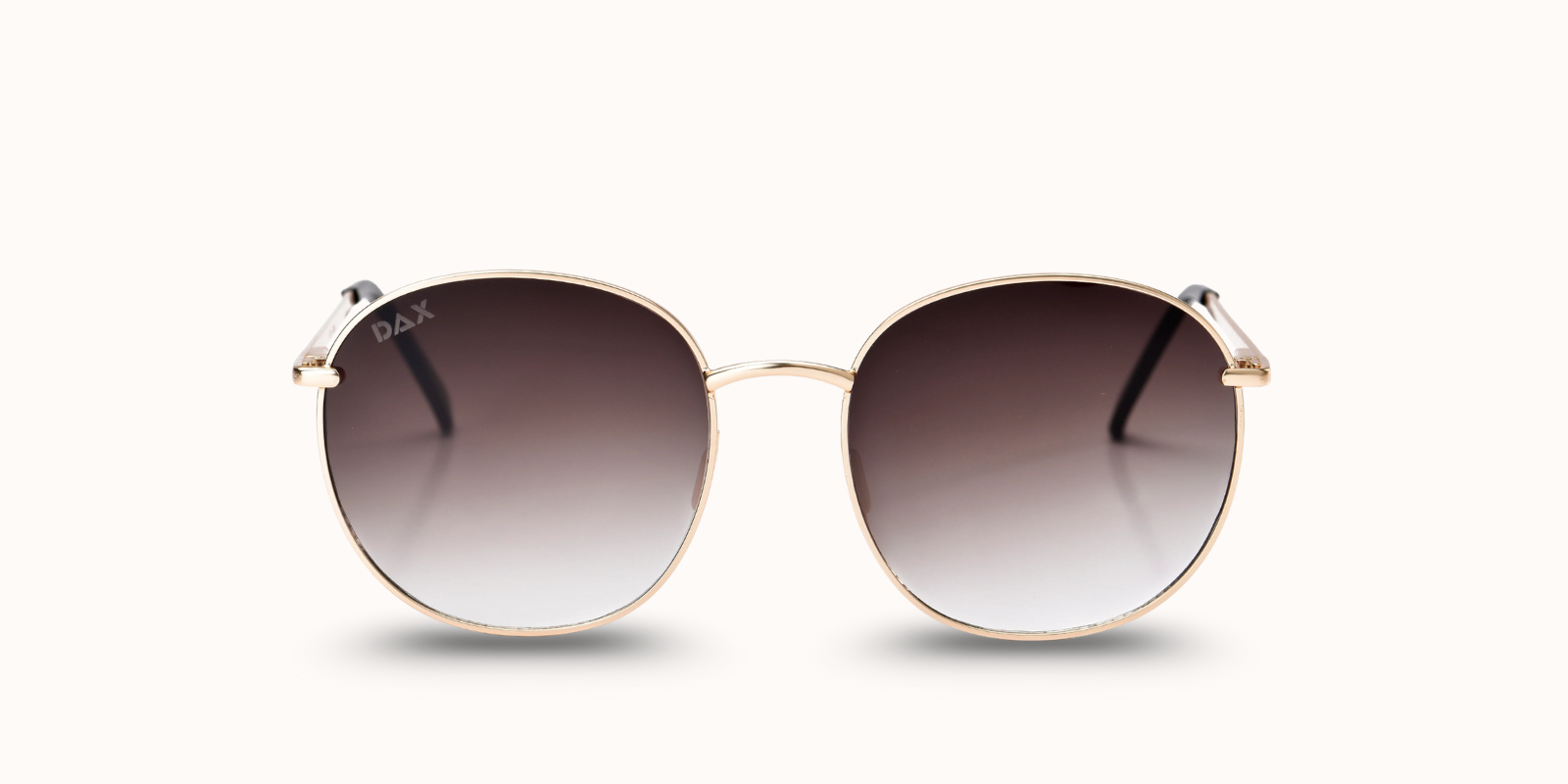 Round sunglasses with gold frame and gradient lenses on a white background