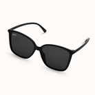Black sunglasses with dark lenses on a white background