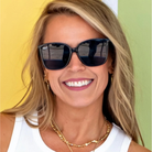 Woman wearing sunglasses with a colorful background
