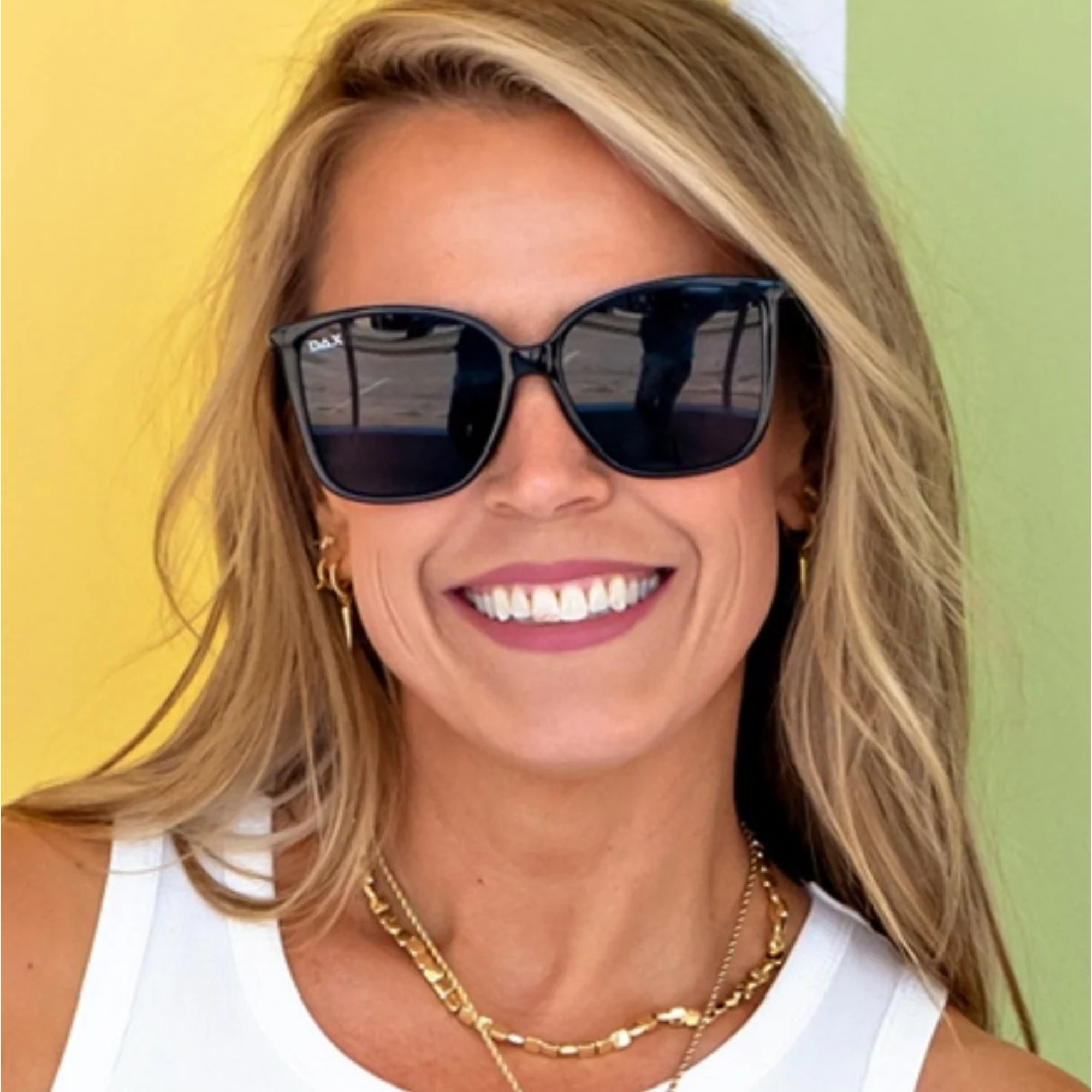 Woman wearing sunglasses with a colorful background