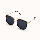 Sunglasses with gold frame and black lenses on a white background
