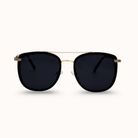 Sunglasses with black lenses and gold frame on a white background
