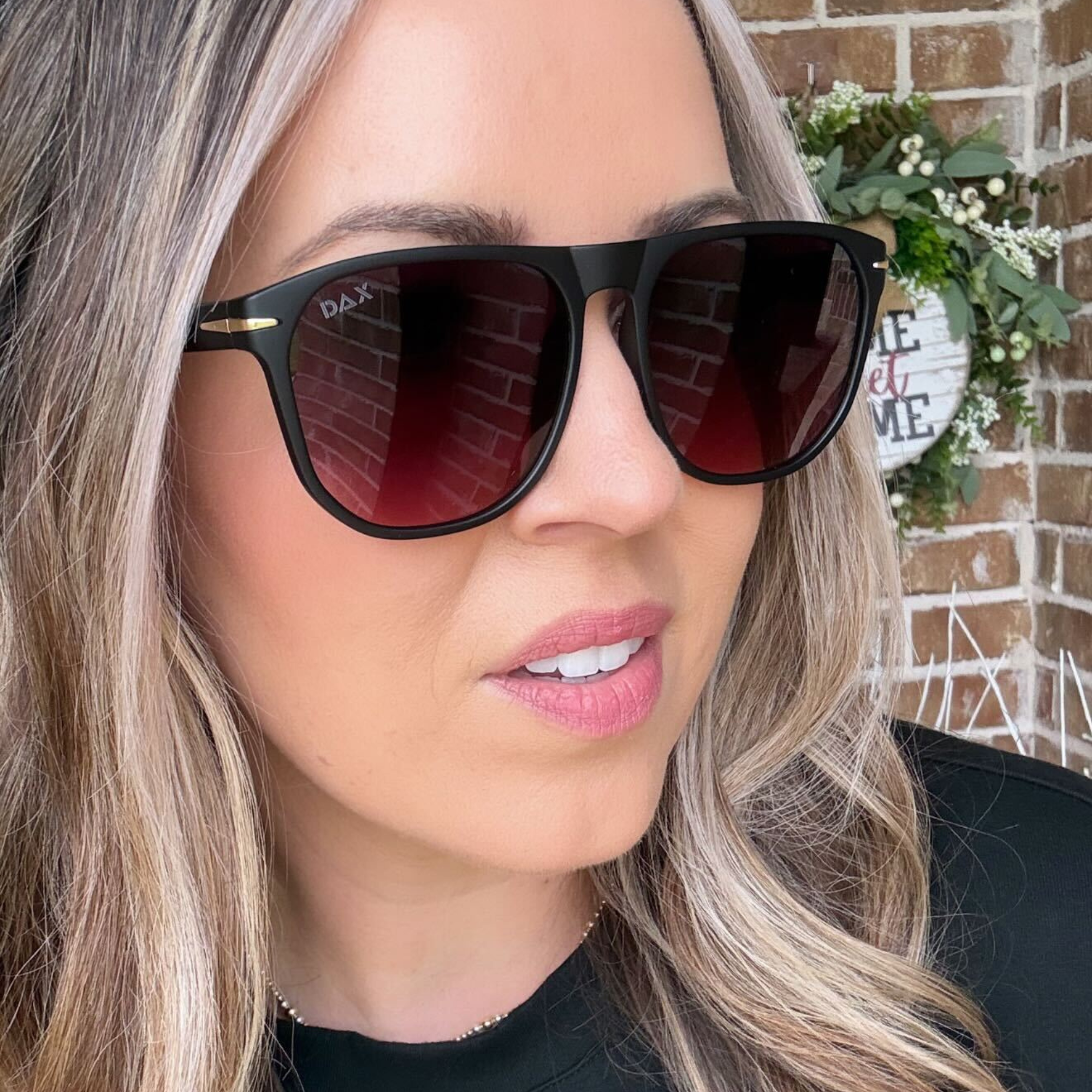 Person wearing black sunglasses with a blurred background