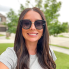 Woman wearing sunglasses with a blurred outdoor background