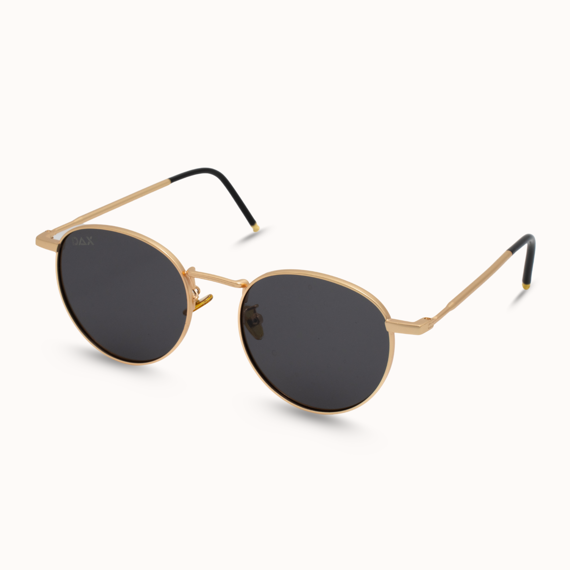 Gold-framed sunglasses with black lenses on a white background