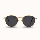 Gold-framed sunglasses with dark lenses on a white background