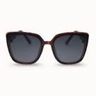 Sunglasses with tortoiseshell frame and dark lenses on a white background