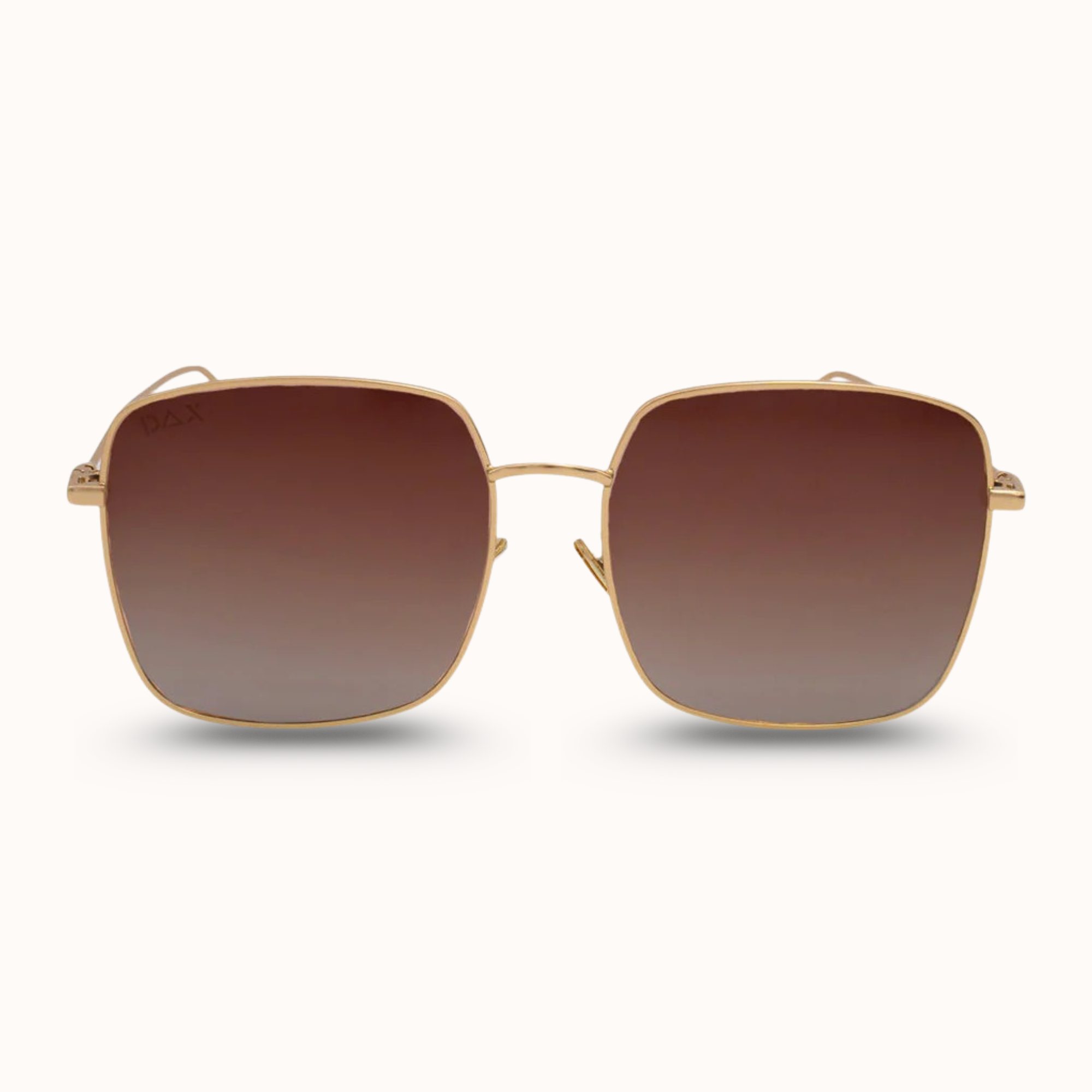 Gold-framed sunglasses with brown gradient lenses on a white background